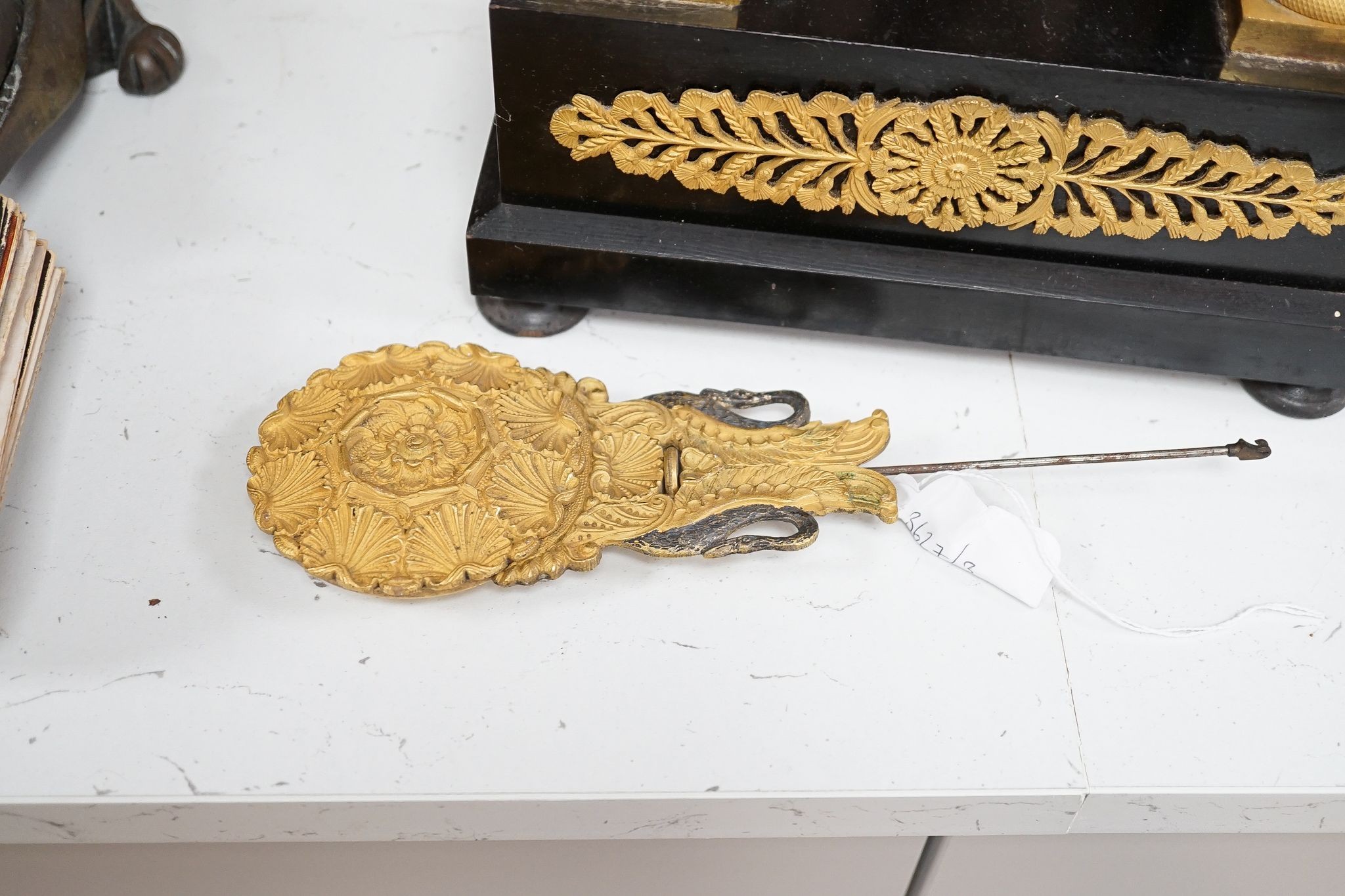 A 19th century ebonised portico mantel clock with brass mounts, 46cms high.